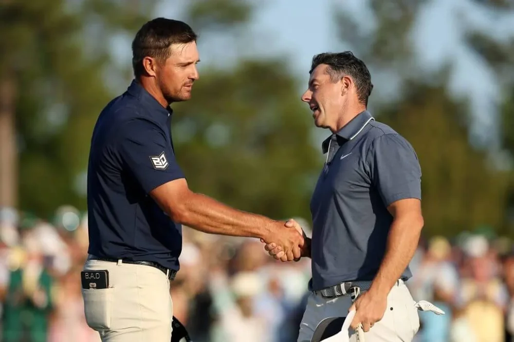 Rory McIlroy, right, shakes hands with Bryson DeChambeau during the final round of the 2025 Masters Tournament.
