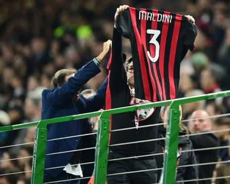AC Milan fans hold up a Paolo Maldini shirt inside the stadium before the Serie A match between AC Milan and Atalanta