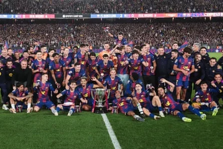 Barcelona players and coaching staff pose for a photo after defeating Real Madrid to secure La Liga